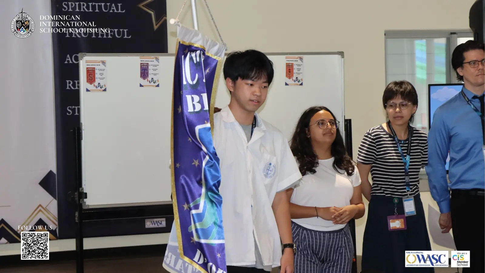 A DISK student presenting a STARS team banner during the welcome program