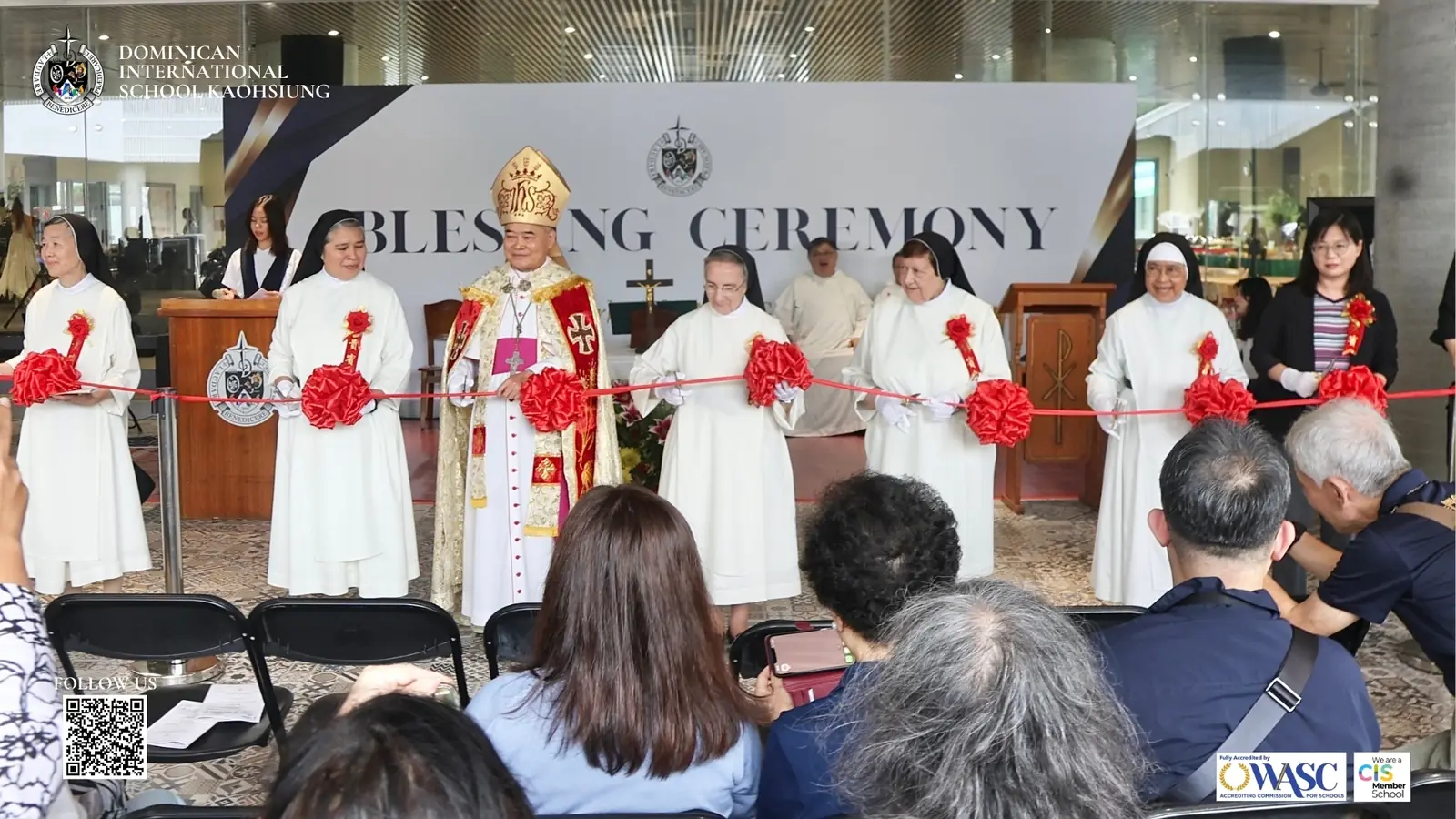 School leaders, clergy, and guests taking part in the new building ribbon cutting